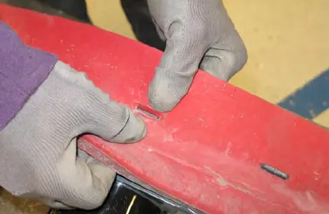 Hands pressing the squeegee blade onto the tabs of the rear squeegee assembly