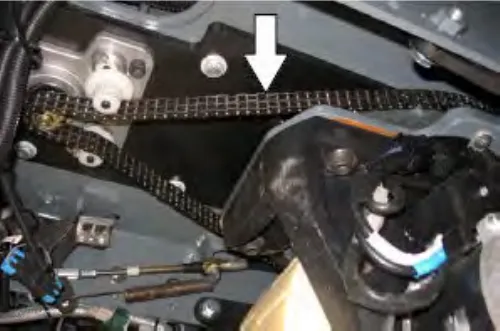 Steering gear chain above the front tire, with an arrow pointing to it