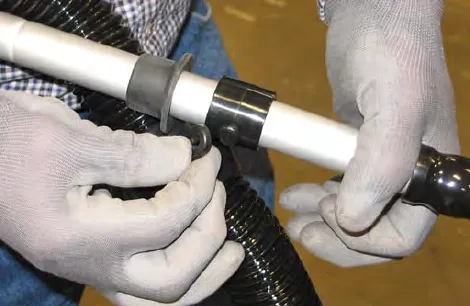 Hands securing the vacuum wand hose collar to the vacuum hose handle