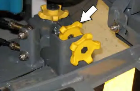 Yellow squeegee tilt lock knob and tilt adjust knob, with an arrow pointing to the tilt lock knob