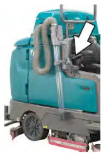Machine with an arrow pointing to the live wand in its storage location
