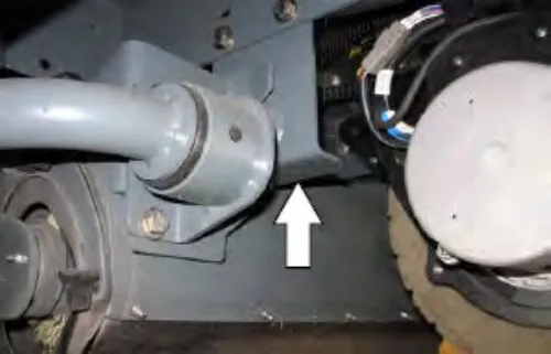 Left front jacking point on a machine with the Pre-Sweep option, with an arrow pointing up at the bracket
