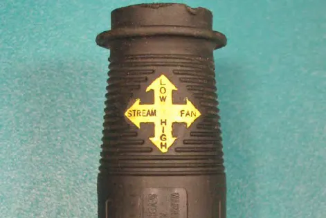 Wand nozzle with a yellow label showing arrows for Low and High pressure up and down, and Stream and Fan left and right