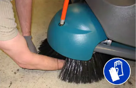 Hand reaching into the center of the Pre-Sweep side brush to remove the cotter pin, plus glove symbol