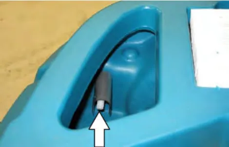 Close view inside the recovery tank with an arrow pointing up at the sensor near the top