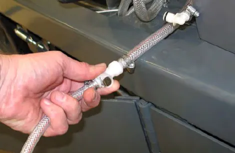 Hand connecting the drain hose to the ec-H2O outlet hose