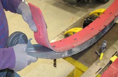 Hands lifting the front squeegee blade off the squeegee assembly