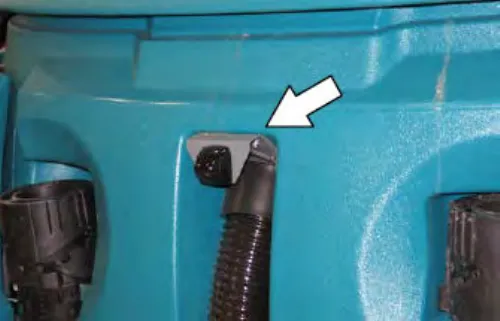 Rearview camera mounted on the recovery tank above the vacuum hose connection, with an arrow pointing at it