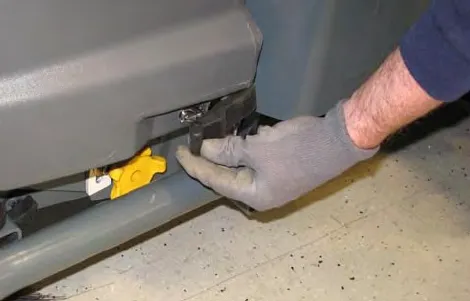 Hand loosening a Pre-Sweep cover latch