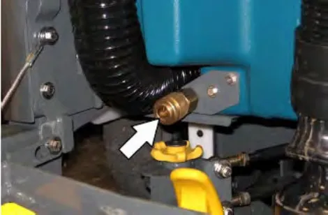 Brass auto-fill connection at the rear of the machine with an arrow pointing at it