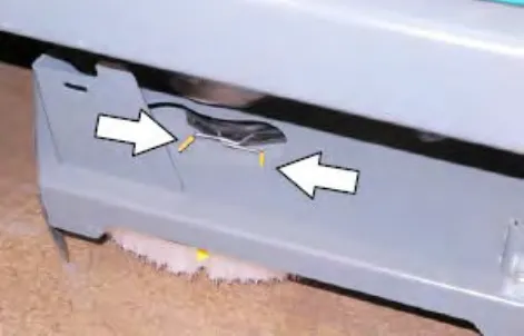 Scrub head side with arrows pointing to the disk brush spring handles