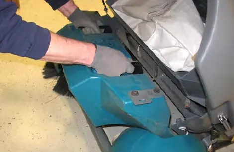 Hands removing the debris hopper from the Pre-Sweep assembly