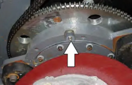 Drive wheel pivot above the drive wheel, with an arrow pointing up at the lubrication point