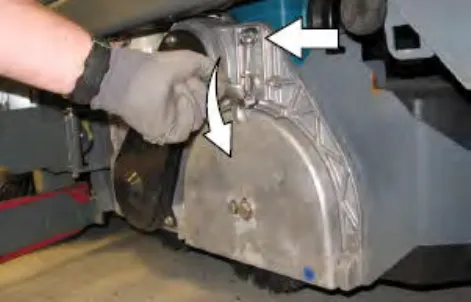 Hand lifting the idler plate retainer handle, with arrows showing the motion