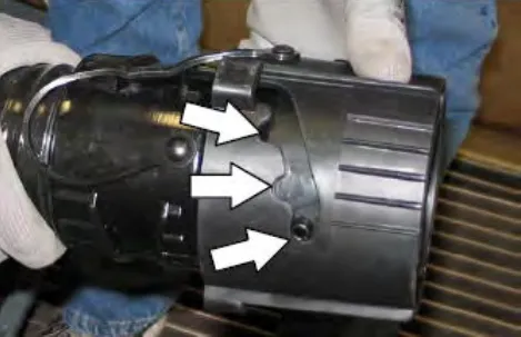 Close view of the drain nozzle with three arrows pointing at the positions to twist it