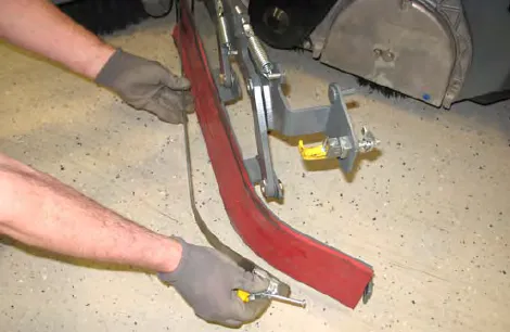 Hands removing the retaining band from the side squeegee assembly