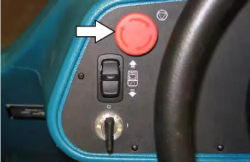 Emergency shut-off button, directional switch and key switch, with an arrow pointing at the red emergency shut-off button