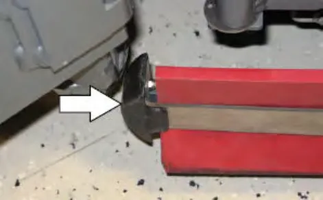 Retaining band hooked onto the retainer tab on the side squeegee assembly, with an arrow pointing to the tab