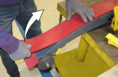 Hands lifting the rear squeegee blade off the squeegee assembly, with an arrow showing the direction