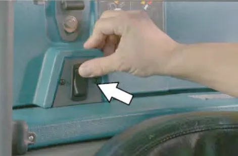 Hand pressing the live wand switch, with an arrow pointing to it