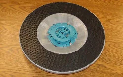 Grip pad driver, a round disk with a black grip-face backing and a blue center hub