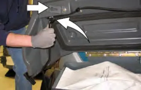 Hand lifting the Pre-Sweep cover and engaging the cover support, with arrows