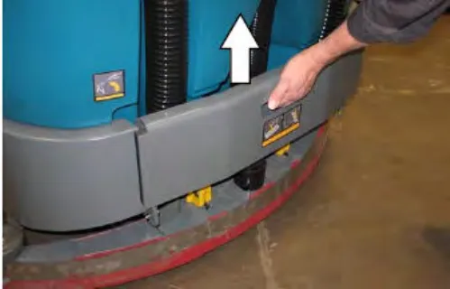 A hand lifting the rear bumper door by its handle, with an arrow pointing up
