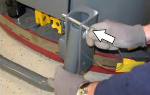 Hand pulling the pin on the rear squeegee protector, with an arrow pointing to the pin