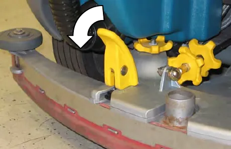 Close view of a yellow mounting handle being turned, with an arrow showing the direction