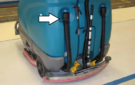 Rear of the machine with an arrow to the solution tank drain hose