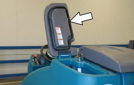 Solution tank cover opened, with an arrow to the cover