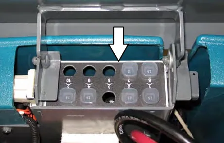 Circuit breaker holder in the front of the battery compartment, with an arrow pointing to the breakers numbered 6 to 10