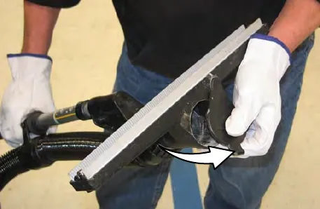 Vacuum wand cap being removed and the nozzle returned to the storage position