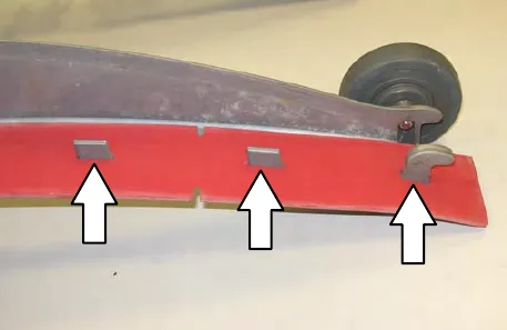 Squeegee blade seated in the outer frame, with three arrows pointing to the tabs