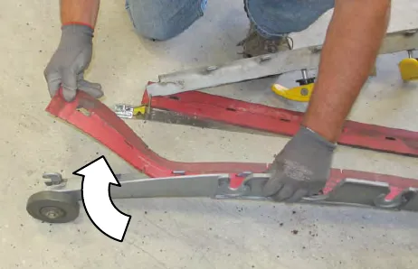 A person peeling the squeegee blade off the outer frame, with an arrow showing the direction