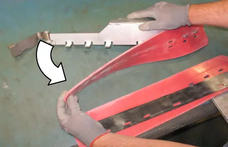 Hands separating the squeegee blade from the frame, with an arrow showing the direction