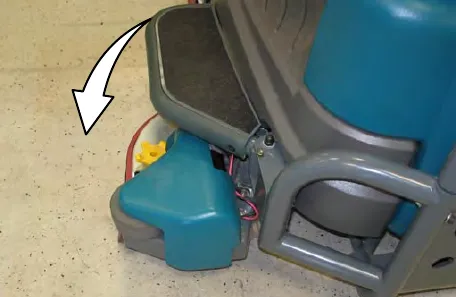 Side of the machine with an arrow showing the side brush swinging out from under the side guard