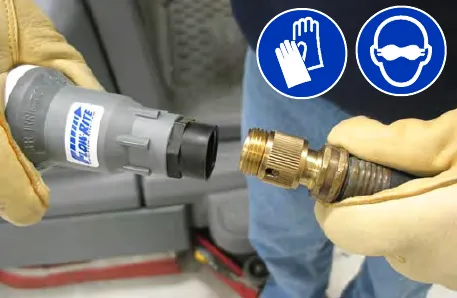 Gloved hands holding the Flow-Rite fill regulator and a brass water hose fitting; gloves and eye protection are required