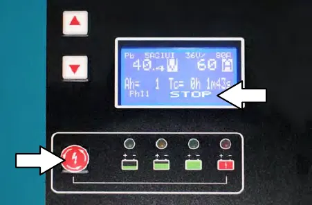 Charger panel showing STOP on the display, with arrows pointing to STOP and to the stop / start / enter button