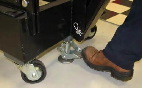 Foot pressing the left side of the battery cart floor lock