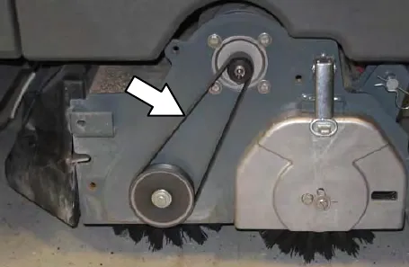 Cylindrical brush scrub head with an arrow pointing to the brush drive belt