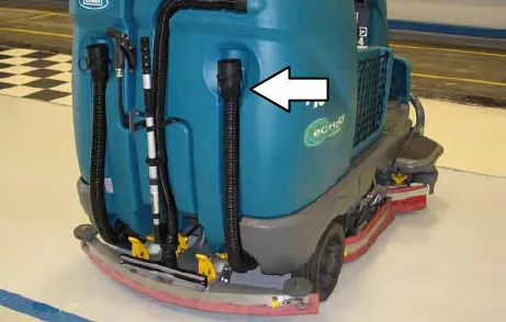 Rear of the machine with an arrow to the recovery tank drain hose