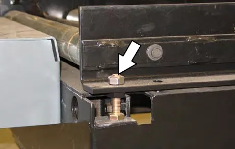 Battery cart roller height adjusting bolt and jam nut, with an arrow to the jam nut