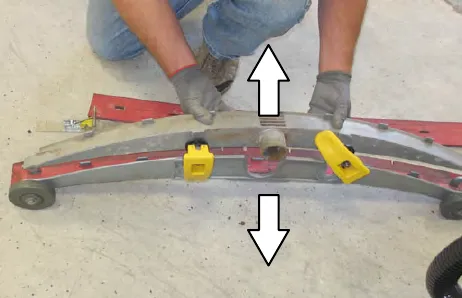 A person pulling the inner frame away from the outer frame, with arrows pointing up and down