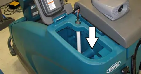 Solution tank fill opening with an arrow pointing down into it
