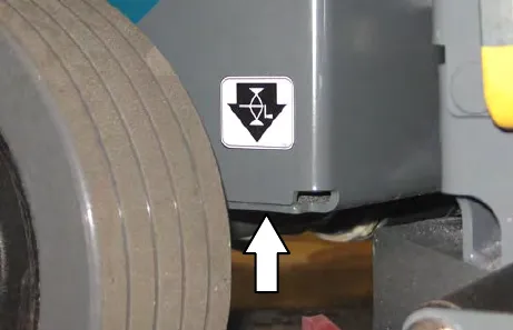 Rear jacking point beside the wheel with the jacking label and an arrow pointing up to it