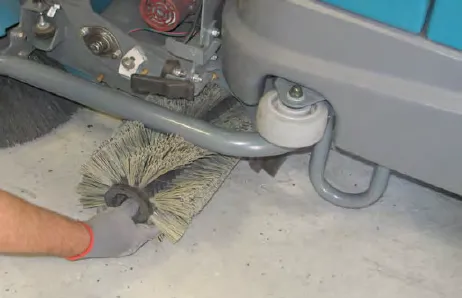 Hand pulling the cylindrical brush out of the Pre-Sweep assembly