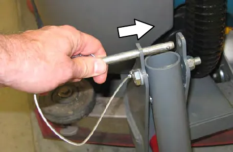 Hand pulling the pin on the rear squeegee protector bar