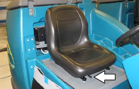 Standard operator seat with an arrow to the front-to-back adjustment lever