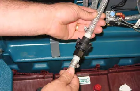 Hands connecting the drain hose to the ec-H2O manifold hose
